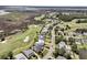Scenic aerial showcasing homes lining a golf course with a marsh and lake backdrop at 1636 Rivertowne Country Club Dr, Mount Pleasant, SC 29466