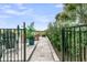 Tranquil backyard entrance with lush greenery, inviting patio seating and serene golf course vistas at 1636 Rivertowne Country Club Dr, Mount Pleasant, SC 29466