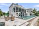 Gorgeous backyard featuring a screened porch, outdoor seating and a sparkling pool with water feature at 1636 Rivertowne Country Club Dr, Mount Pleasant, SC 29466
