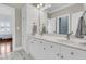 Modern bathroom features double vanity with white cabinets, marble countertop and black and white tiled floors at 1636 Rivertowne Country Club Dr, Mount Pleasant, SC 29466
