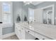 Bright bathroom features a large vanity, a large mirror, and plantation shutters at 1636 Rivertowne Country Club Dr, Mount Pleasant, SC 29466