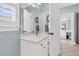 Powder-blue bathroom with white cabinets, large mirror, and plantation shutters at 1636 Rivertowne Country Club Dr, Mount Pleasant, SC 29466