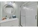 Clean bathroom featuring a modern white vanity with framed round mirror and a glass-enclosed shower at 1636 Rivertowne Country Club Dr, Mount Pleasant, SC 29466