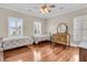 Bright bedroom with hardwood floors, two twin beds, dresser and natural light from the window with plantation shutters at 1636 Rivertowne Country Club Dr, Mount Pleasant, SC 29466