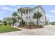 Stately two-story home with a grand front porch and pristine landscaping, enhanced by mature palms at 1636 Rivertowne Country Club Dr, Mount Pleasant, SC 29466