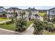 Beautiful two-story home boasting a manicured lawn, flowering trees and elegant exterior finishes at 1636 Rivertowne Country Club Dr, Mount Pleasant, SC 29466