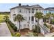 Desirable two-story home with a manicured lawn, mature landscaping, and elegant architectural details at 1636 Rivertowne Country Club Dr, Mount Pleasant, SC 29466