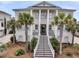 Stately two-story home with a grand entrance staircase and classic architectural details at 1636 Rivertowne Country Club Dr, Mount Pleasant, SC 29466