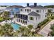 Stunning home featuring a private pool, screened porch, rooftop deck, and lush landscaping at 1636 Rivertowne Country Club Dr, Mount Pleasant, SC 29466