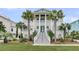 Elegant facade features columns, dual staircases, lush landscaping, and a perfectly manicured lawn at 1636 Rivertowne Country Club Dr, Mount Pleasant, SC 29466