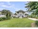 Stunning Southern-style home features a manicured lawn and stately columns, embodying classic elegance and curb appeal at 1636 Rivertowne Country Club Dr, Mount Pleasant, SC 29466