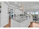 Open-concept kitchen boasts a center island, marble countertops, and hardwood floors at 1636 Rivertowne Country Club Dr, Mount Pleasant, SC 29466