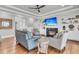 Bright living room features a fireplace, built-in shelving, wood floors, and comfortable seating at 1636 Rivertowne Country Club Dr, Mount Pleasant, SC 29466