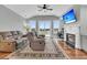 Spacious living room features a fireplace, hardwood floors, ceiling fan, and comfortable couches at 1636 Rivertowne Country Club Dr, Mount Pleasant, SC 29466