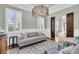 Bright living room with elegant chandelier, windows, and comfortable seating at 1636 Rivertowne Country Club Dr, Mount Pleasant, SC 29466