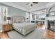 Spacious main bedroom with fireplace, wood floors, and views into office area at 1636 Rivertowne Country Club Dr, Mount Pleasant, SC 29466