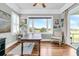 Bright home office with large window overlooking golf course view, hardwood floors, and ceiling fan at 1636 Rivertowne Country Club Dr, Mount Pleasant, SC 29466