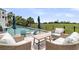 Outdoor lounge area with plush seating, offering relaxation by a pool with golf course views at 1636 Rivertowne Country Club Dr, Mount Pleasant, SC 29466