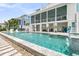 Expansive backyard pool with water features, surrounded by lush landscaping and luxurious outdoor seating areas at 1636 Rivertowne Country Club Dr, Mount Pleasant, SC 29466