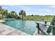 Relaxing backyard pool with a calming water feature, overlooking a lush green landscape at 1636 Rivertowne Country Club Dr, Mount Pleasant, SC 29466