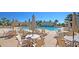 Community pool features outdoor seating with umbrellas, perfect for relaxing by the clear blue water at 1636 Rivertowne Country Club Dr, Mount Pleasant, SC 29466