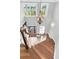 Elegant staircase with wood treads, white risers, large chandelier, and natural light at 1636 Rivertowne Country Club Dr, Mount Pleasant, SC 29466