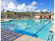 Community pool boasts clear blue water, sun loungers, shaded seating areas, and well-maintained pool house structures at 1636 Rivertowne Country Club Dr, Mount Pleasant, SC 29466