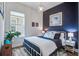 Stylish bedroom features a modern color scheme, contemporary lighting, and ample natural light, creating a cozy retreat at 1641 Adventure Xing, Mount Pleasant, SC 29466