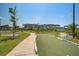 A bocce ball court sits in front of apartments in a community with sidewalks, trees, and parking at 1641 Adventure Xing, Mount Pleasant, SC 29466