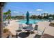 Community pool with palm trees, lounge chairs, umbrella covered tables, and blue skies at 1641 Adventure Xing, Mount Pleasant, SC 29466
