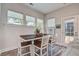 Bright dining area features a dark wood table with seating for four, complemented by natural light from multiple windows at 1641 Adventure Xing, Mount Pleasant, SC 29466