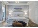 Beautiful main bedroom with a decorative wall and large windows is enhanced by a modern chandelier and upscale furnishings at 1641 Adventure Xing, Mount Pleasant, SC 29466