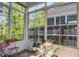 Bright sunroom surrounded by windows and views of the lush green outdoors at 1641 Adventure Xing, Mount Pleasant, SC 29466