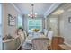 Bright dining area featuring a chandelier, windows, and hardwood flooring at 1666 Bridwell Ln, Mount Pleasant, SC 29466