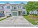 Charming two-story home featuring a green garage door and manicured lawn at 1666 Bridwell Ln, Mount Pleasant, SC 29466