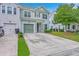 Charming two-story home featuring a green garage door and manicured lawn at 1666 Bridwell Ln, Mount Pleasant, SC 29466