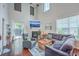 Cozy living room with a fireplace, hardwood floors, and large windows at 1666 Bridwell Ln, Mount Pleasant, SC 29466