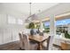 Elegant dining room with a wooden table, stylish chandelier, and a view of the pool at 1713 Banning St, Mount Pleasant, SC 29466