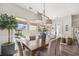 Elegant dining room with a wooden table, stylish chandelier, and a view of the pool at 1713 Banning St, Mount Pleasant, SC 29466