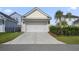 Attached two-car garage showcasing a clean, modern design with a paved driveway and manicured landscaping at 1713 Banning St, Mount Pleasant, SC 29466