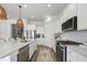 Bright, modern kitchen with stainless steel appliances, quartz countertops, and a spacious island at 1713 Banning St, Mount Pleasant, SC 29466