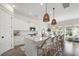 Bright, open kitchen featuring white cabinetry, a large island, and modern pendant lighting at 1713 Banning St, Mount Pleasant, SC 29466