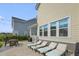 Charming outdoor patio with lounge seating, dining table, and grill, ideal for enjoying the backyard space at 1713 Banning St, Mount Pleasant, SC 29466