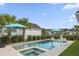Beautiful pool area surrounded by lush landscaping, featuring turquoise umbrellas for shade and a basketball hoop at 1713 Banning St, Mount Pleasant, SC 29466