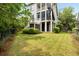 Expansive backyard view with a lawn, a screen porch, and a spiral staircase at 1878 Headquarters Plantation Dr, Johns Island, SC 29455