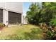 Backyard with a green lawn, a raised garden bed, tropical plants, and a wooden fence with some stairs at 1878 Headquarters Plantation Dr, Johns Island, SC 29455