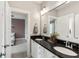 Double vanity in a bathroom featuring dark countertops, white cabinetry, and modern fixtures at 1878 Headquarters Plantation Dr, Johns Island, SC 29455