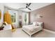 Stylish bedroom with a decorative accent wall, large windows, and a cozy ambiance, perfect for relaxation at 1878 Headquarters Plantation Dr, Johns Island, SC 29455