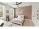 Stylish bedroom with a decorative accent wall, large windows, and a cozy ambiance, perfect for relaxation at 1878 Headquarters Plantation Dr, Johns Island, SC 29455