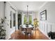 Bright dining room with hardwood floors, modern chandelier and ample natural light at 1878 Headquarters Plantation Dr, Johns Island, SC 29455